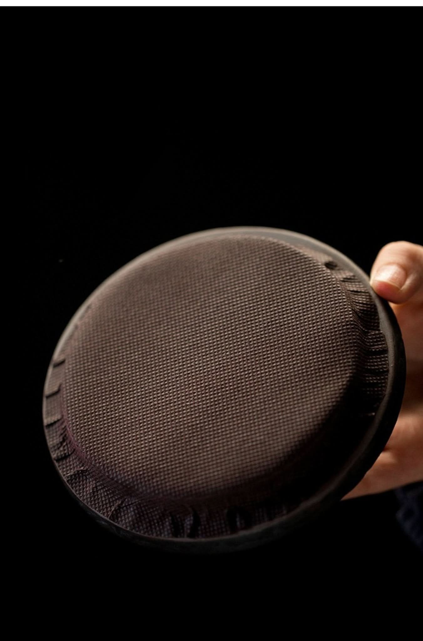Brown textured Pottery Japanese Tea Jar lid held by hand.